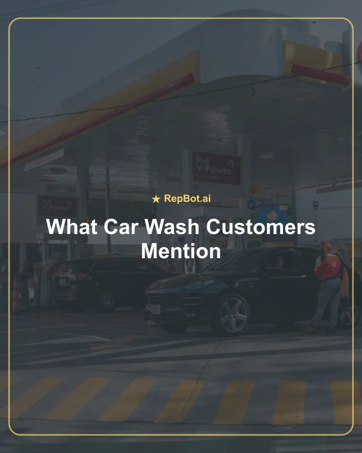Car wash attendant assisting a driver at an automated pay station with vacuum stations nearby.