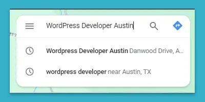 Auto-complete suggestions in a Google search bar for 'WordPress Developer Austin' showing two options, one for a specific address and one for developers near Austin, TX.